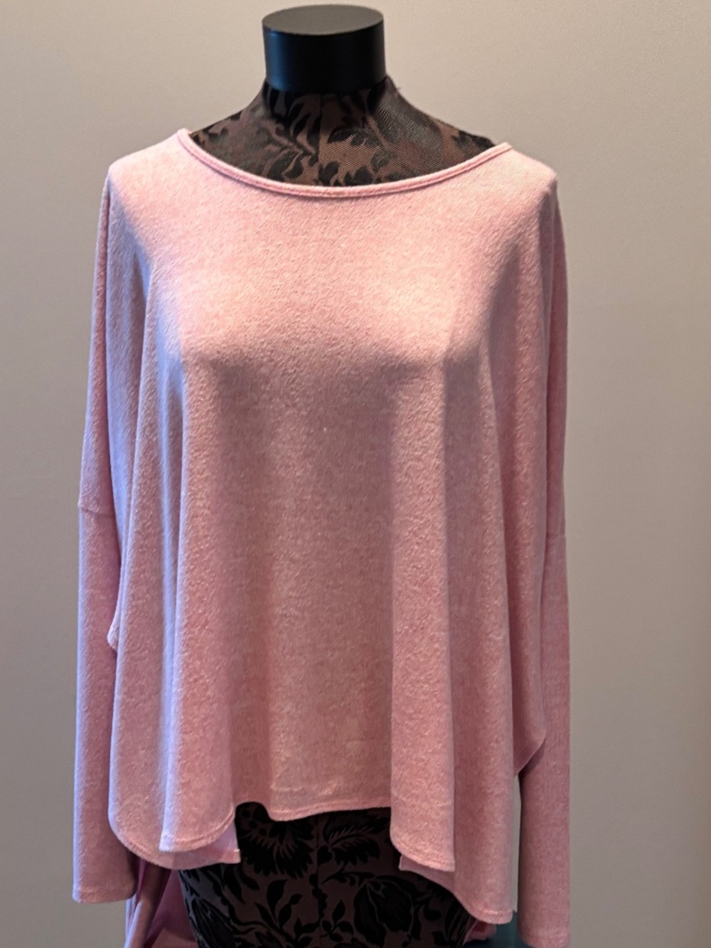 pink sweater, longer in the back to create a flowing style